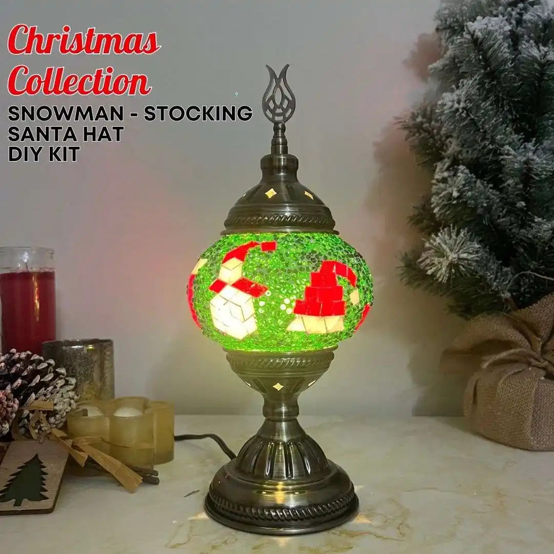 Decorative lamp with Christmas-themed design on a table with festive decorations.