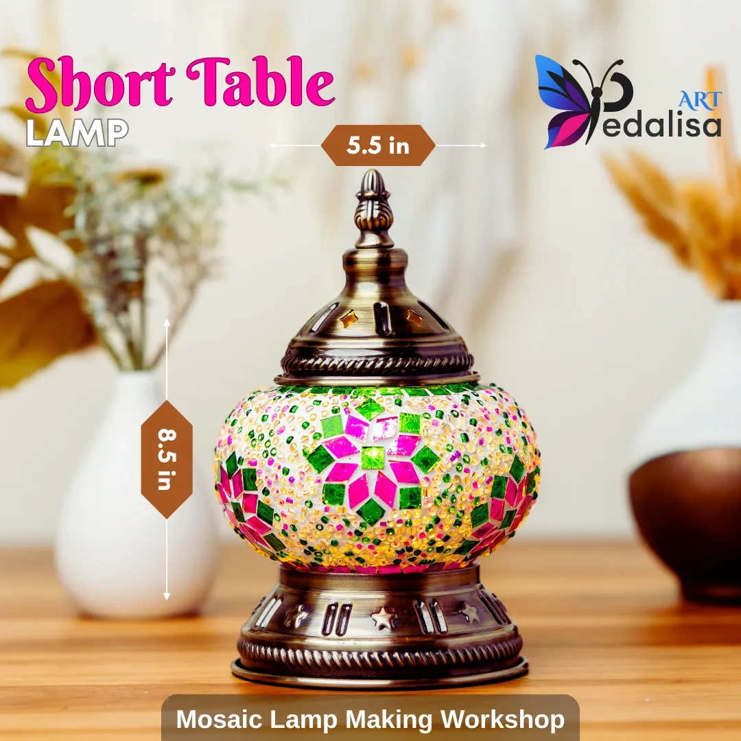 A decorative short table lamp with a colorful mosaic glass globe and ornate bronze metal base, shown on a wooden surface with decorative vases in the background. Text overlays indicate dimensions (5.
