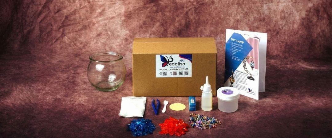 DIY kit with a box, and colorful mosaic materials on a brown background