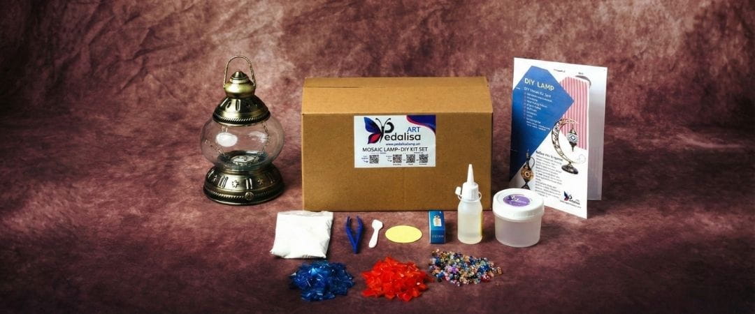 DIY Kit of items including a lamp, box, and various small objects on a textured brown background