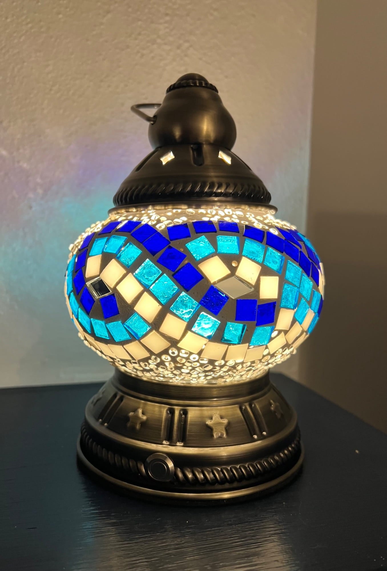 Mosaic rechargeable lamp with blue and white pattern on a dark surface