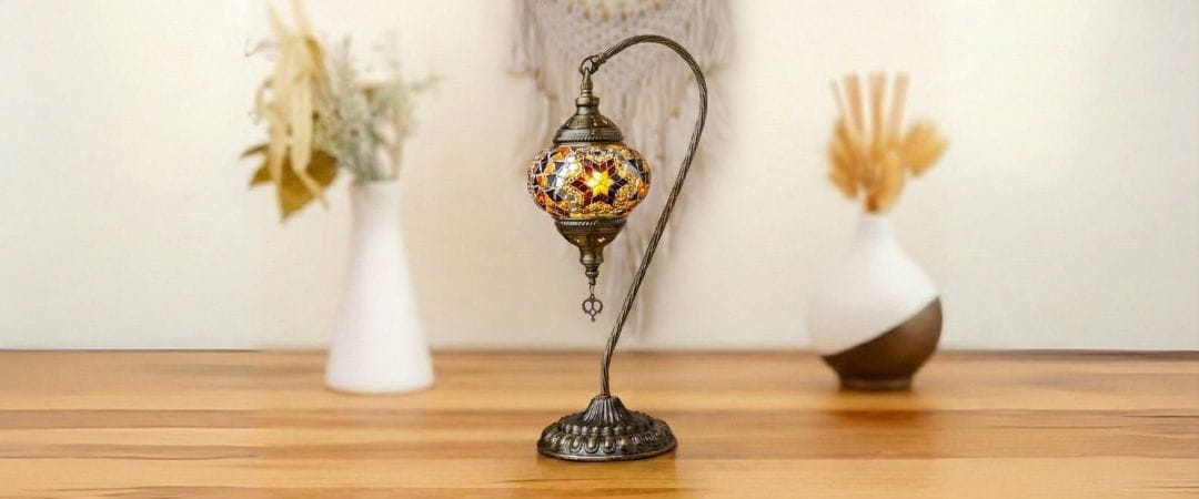 Decorative swan lamp with mosaic design on a wooden surface