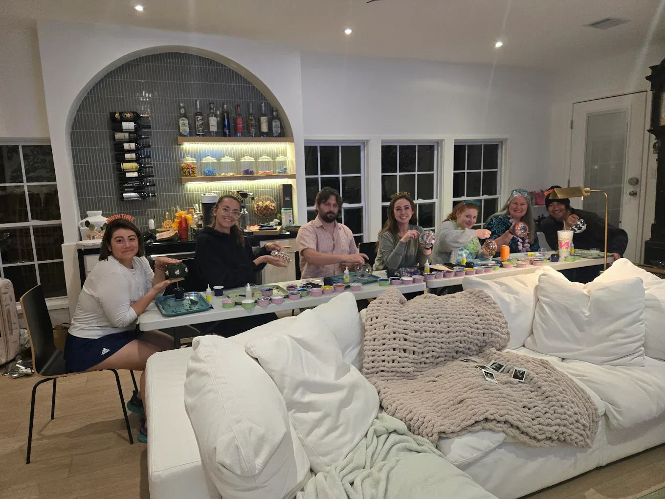 Adults enjoying a creative mosaic activity together at a home gathering