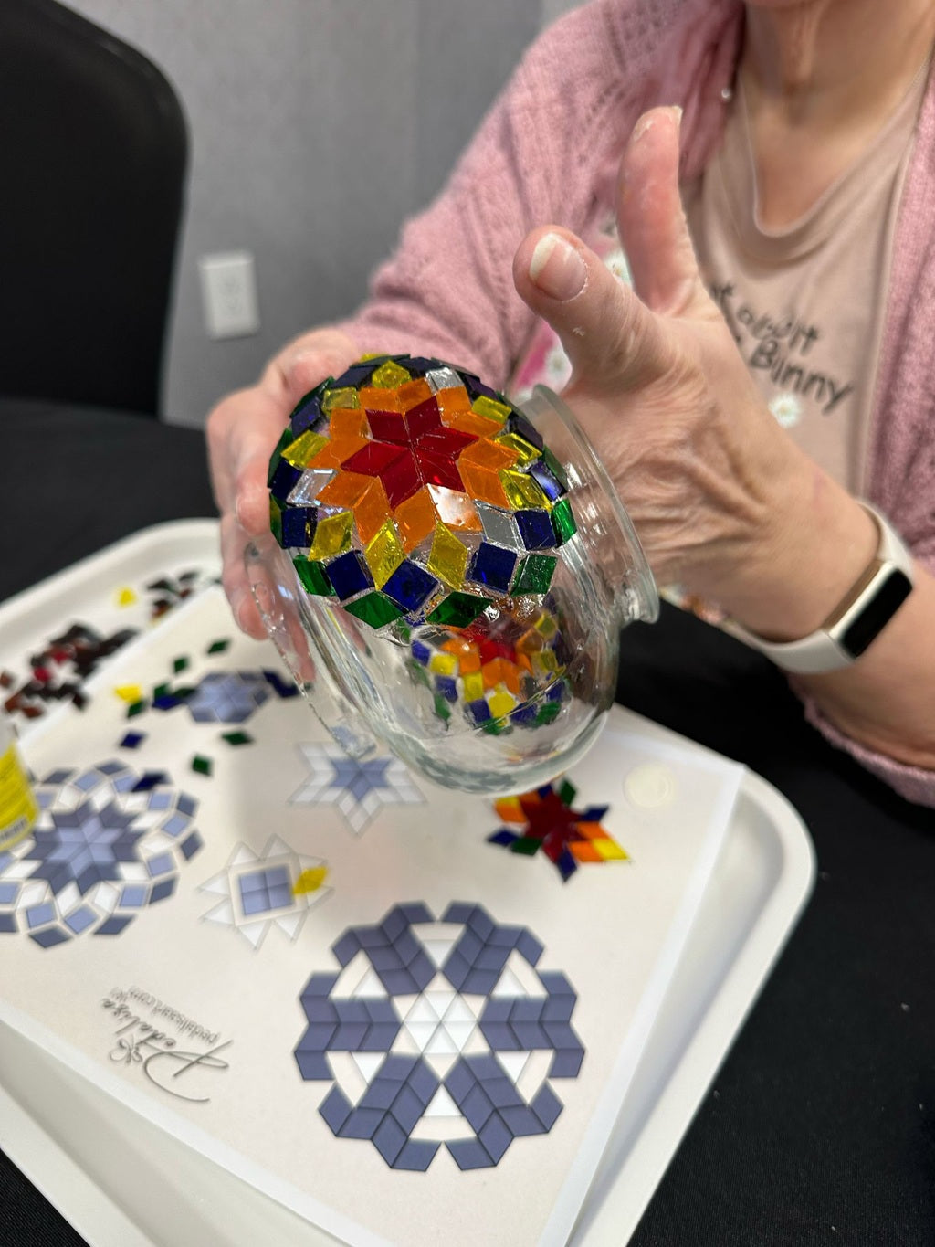 Participants creating Turkish mosaic lamps at a workshop in Pennsylvania, surrounded by colorful glass tiles and traditional Turkish decor.