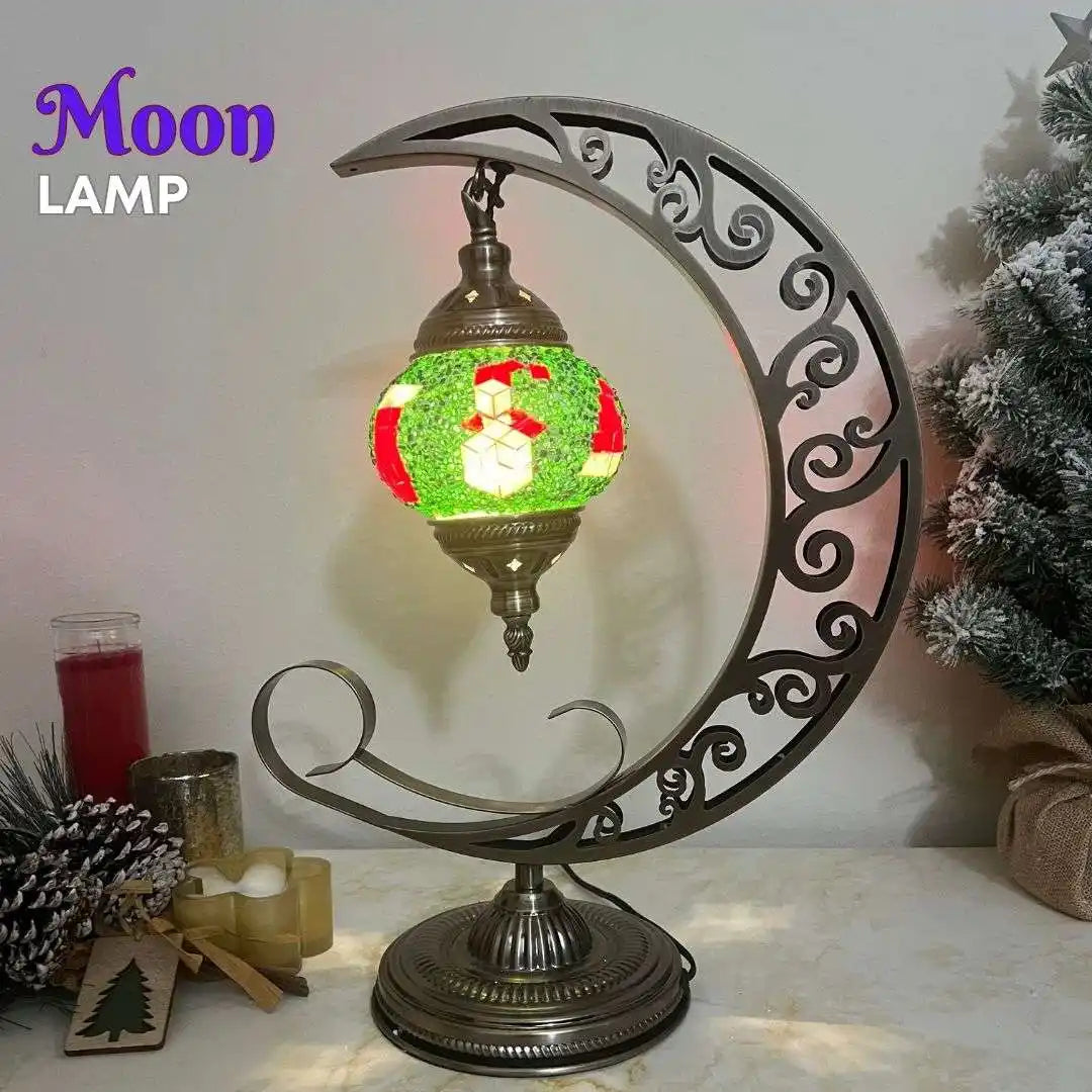 Decorative moon-shaped lamp with a festive design on a table.