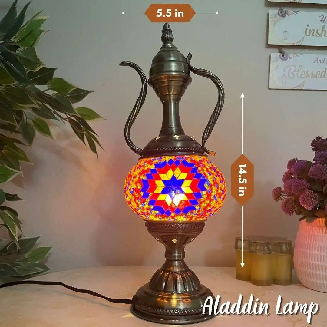 Decorative lamp with colorful mosaic design and measurements, placed on a surface with plants and jars in the background.