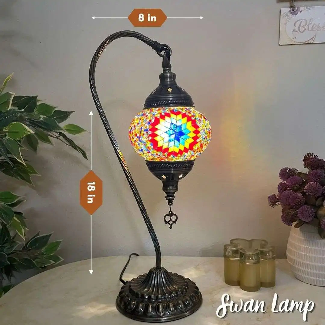 Colorful mosaic table lamp with measurements on a white surface with decorative items.