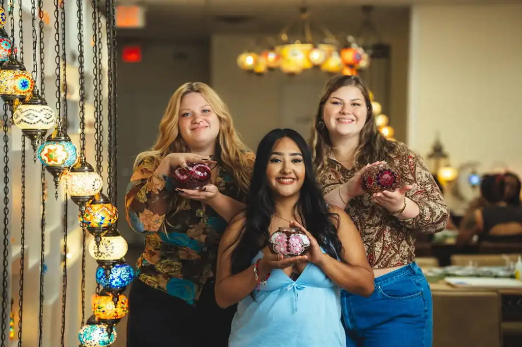 Group of friends having fun at a mosaic art workshop in the USA