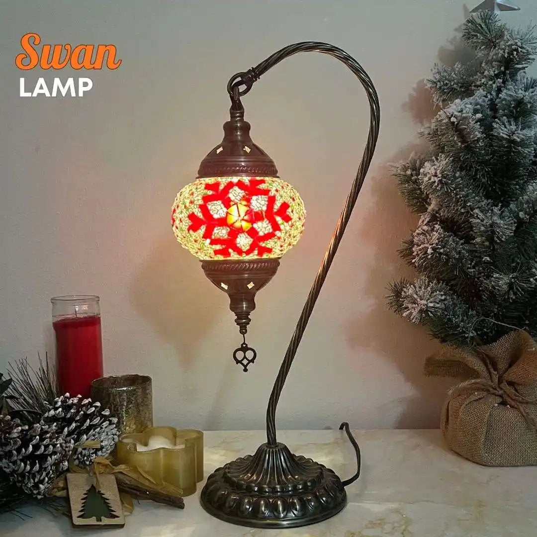Decorative swan lamp with red snowflake pattern mosaic glass shade and curved bronze stand