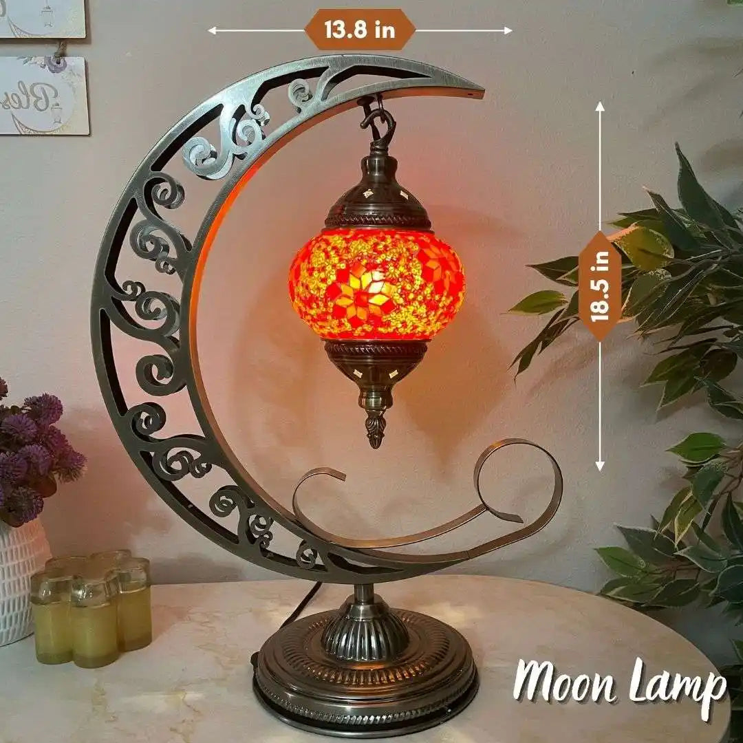 Decorative turkish moroccan mosaic moon lamp with a floral glass shade on a marble surface.