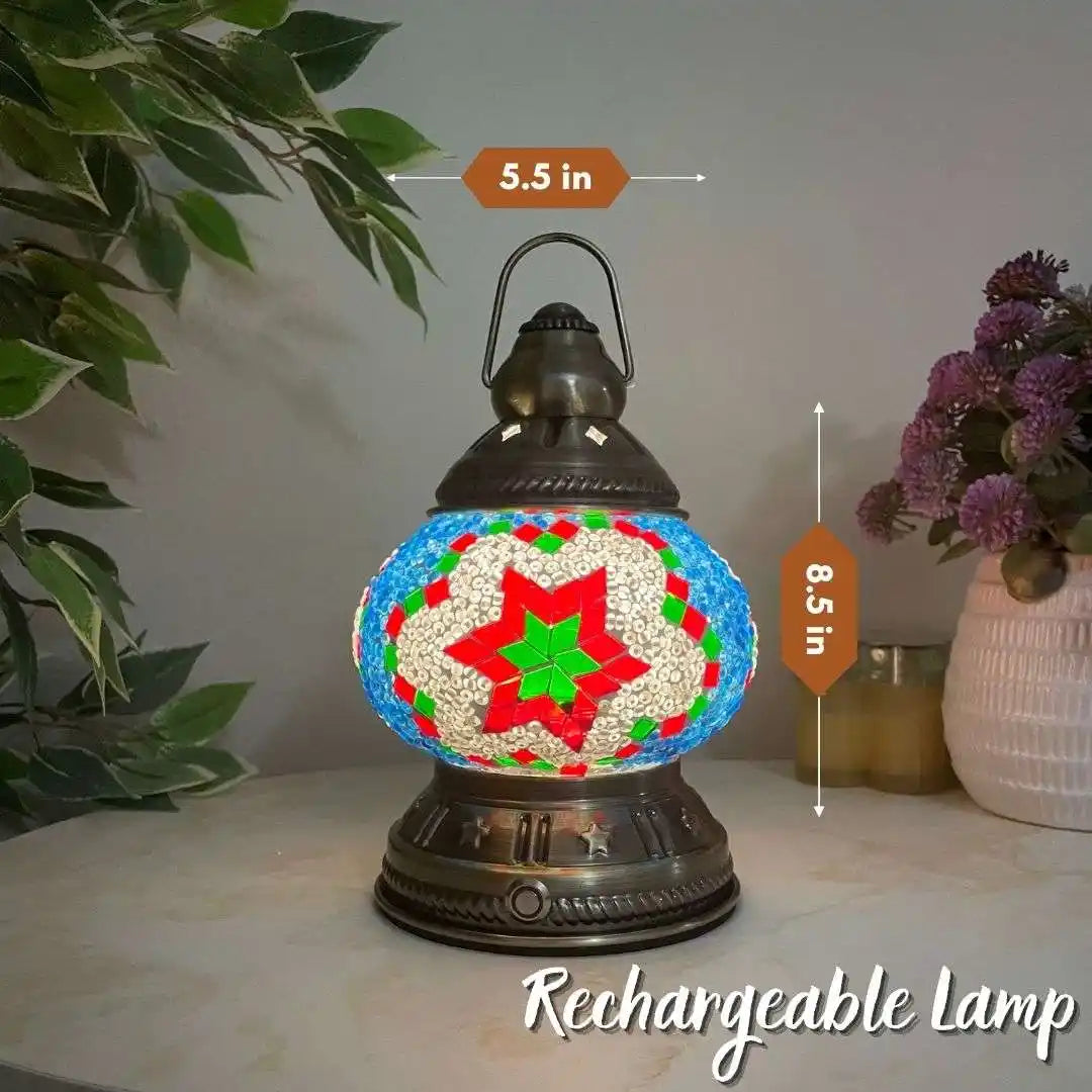 Decorative Turkish Moroccan mosaic rechargeable lamp with measurements on a surface with plants and flowers in the background.