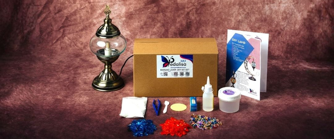 Mosaic Lamp diy kit with a cardboard box, lamp, and various items on a brown background