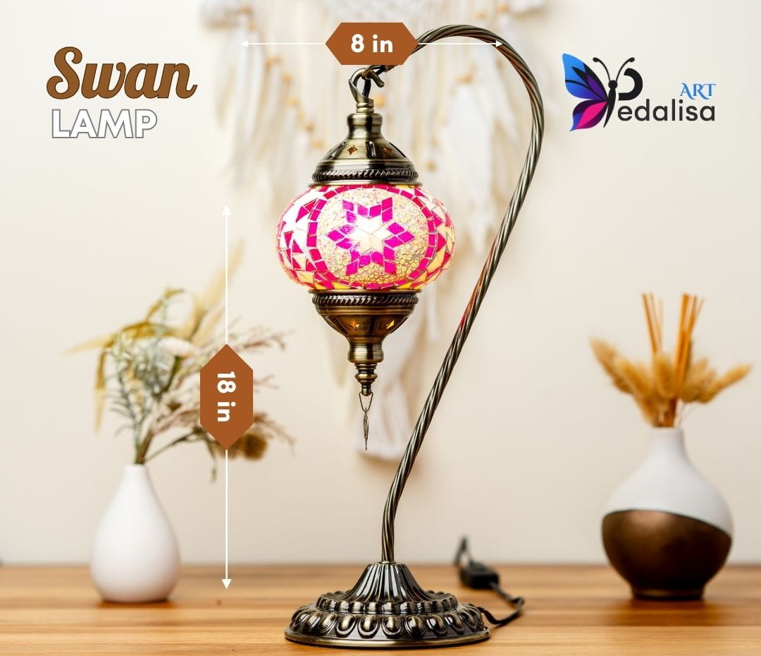 Decorative swan lamp with a colorful glass shade on a wooden surface